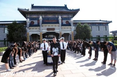      追悼會后，周云露的哥哥手捧妹妹的遺像走出靈堂，親友及同學鞠躬送別。